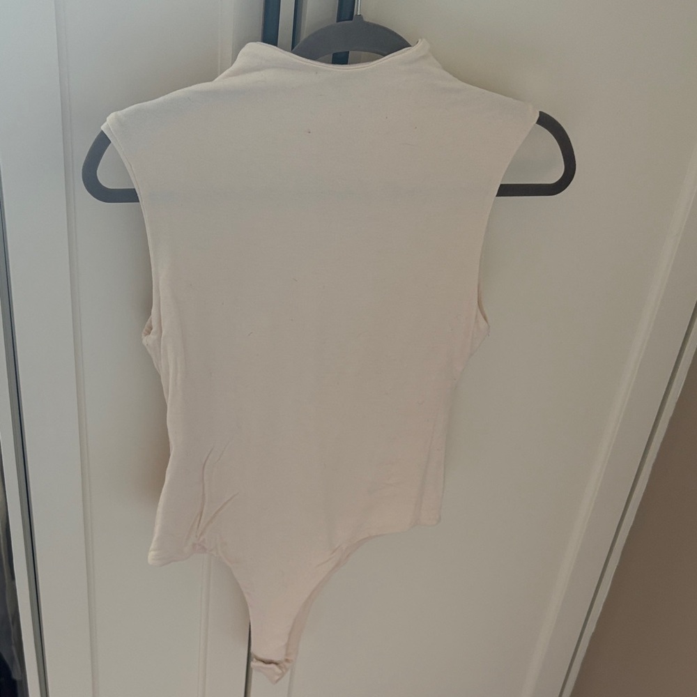 The Post Sleeveless Cream Bodysuit